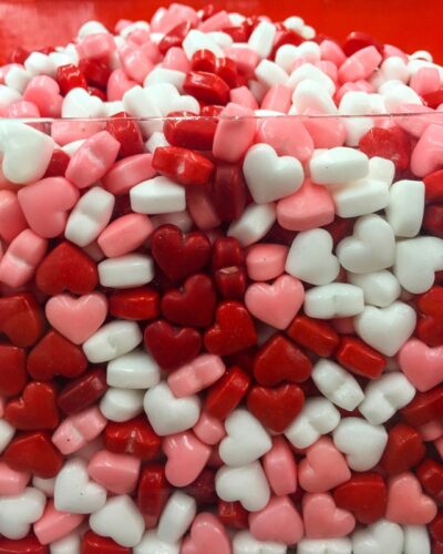 Cross-section of a red, pink, and white candy hearts behind glass